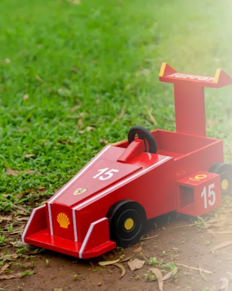 Handcrafted wooden race-car prop used in baby shoots