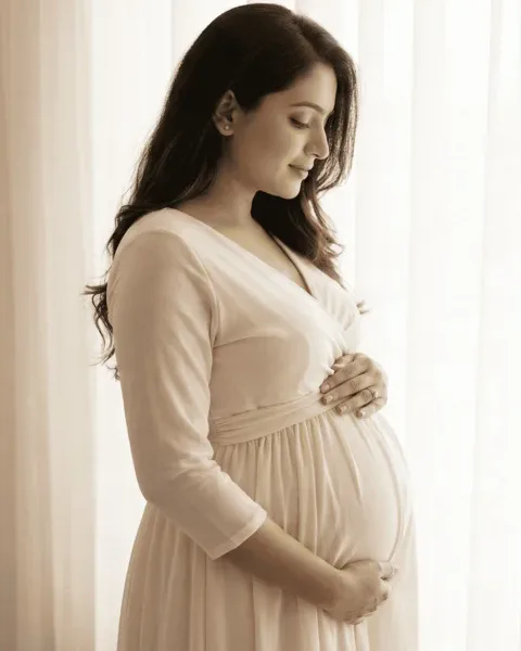 Mother-to-be in a flowing gown at a maternity shoot